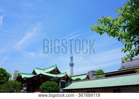 Tokyo / Japan - May 05, 2019: Kameido Tenjin Shrine. Towers Behind The Shrine. Blue Sky
