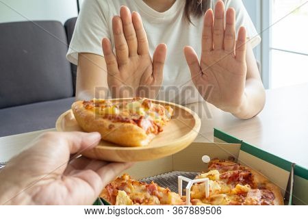 Woman Controls The Food, Using Her Hands To Push The Pizza Dish. Stop Eating Starchy And Fatty Foods