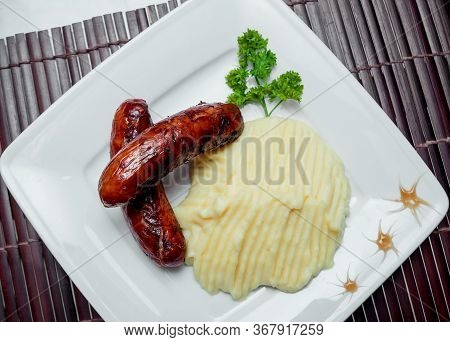 Potatoe With Sousages On The White Plate