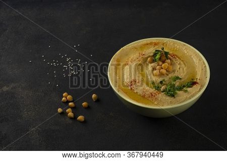 Humus. Chickpea Puree Appetizer. Dark Background. Close-up.