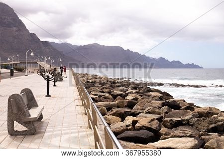 Agaete, Las Palmas - October 17, 2019: Seafront With Street Lights And Benches Near Atlantic Ocean, 