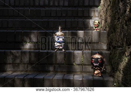 Ravana, Giantess And Hanuman. Standing On A Stone Stairway With Light Shining Down. Traveller Doll.