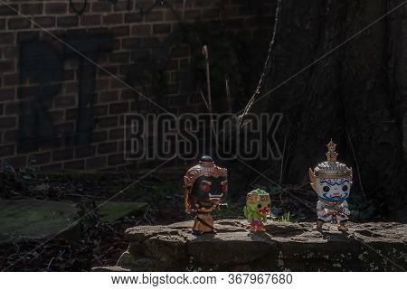 Ravana, Giantess And Hanuman Standing On A Stone Fence Around A Large Tree In The Cemetery. Travelle