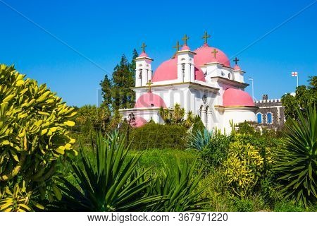 Place of worship and pilgrimage. Gorgeous green south park. Capernaum, Lake Tiberias. The Monastery of the Holy Twelve Apostles. Israel. The concept of religious pilgrimage