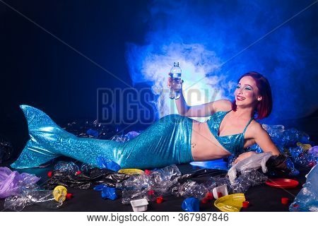 Ocean Plastic Pollution Concept. Mermaid Lives To Polluted Habitat.