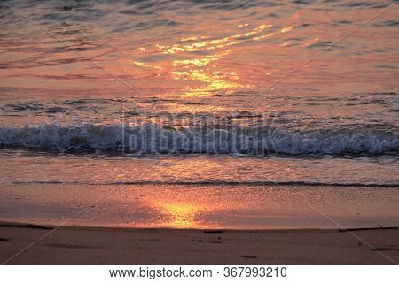 CANDOLIM, INDIA - FEBRUARY 18, 2020: Wave rolling over the sands on Candolim Beach, North Goa, India