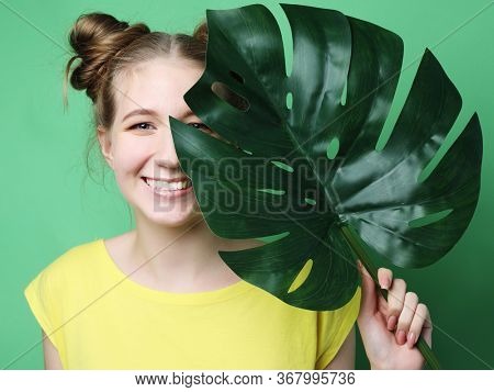 lifestyle and people concept: young woman with a leaf