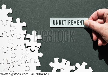 Unretirement Concept Image. Puzzle Pieces Half Assembled And Separate. Hand Holding Piece Of Paper, 