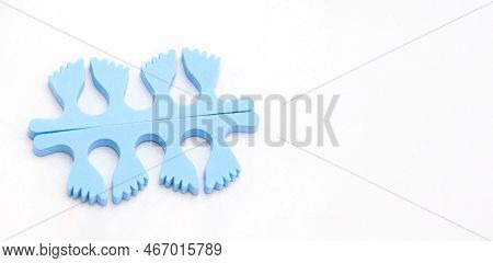 A Pair Of Blue Toe Separators In The Form Of Small Feet, Isolated With Copy Space