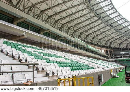 Empty Seats In Modern Football Stadium With Roof. Green And White Tribunes. Seats Of Tribune On Spor