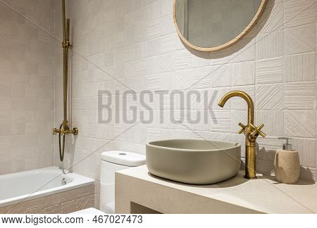 Bright Bathroom In Soothing Pastel Colors With Textured Ceramic Tiles. Attractive Oval Sink. Faucets