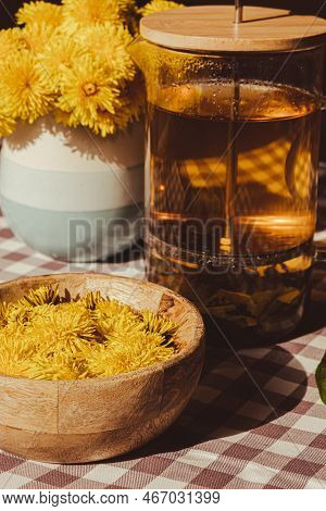 Preparing Dandelion Flower Healthy Tea In Glass Cup On Table. Herbal Medicine Delicious Tisane Tea F
