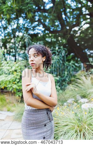 Young African American Multiracial Woman In Midi Pencil Skirt With Front Button Slit In Park Or Stre