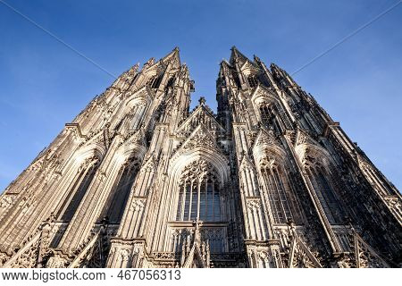 Cologne Cathedral Seen From Below With Blue Sky. Cologne Cathedral, Or Kolner Dom, Is The Main Landm