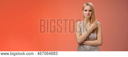 Jealous Displeased Angry Young Revengeful Blond Ex-girlfriend In Luxurious Silver Shiny Dress Frowni