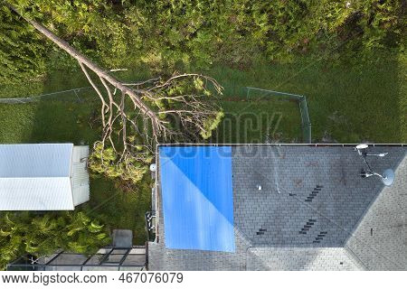Aerial View Of Damaged In Hurricane Ian House Roof Covered With Blue Protective Tarp Against Rain Wa