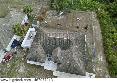 Aerial View Of Typical Contemporary American Private House With Roof Top Covered With Asphalt Shingl