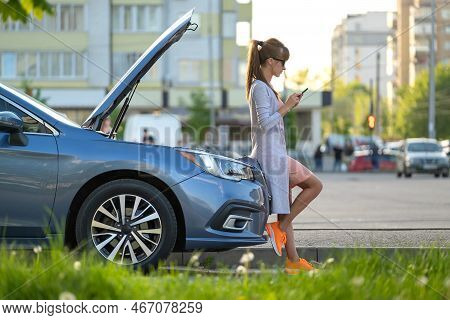 Helpless Woman Standing Near Her Car With Open Hood Takling On Mobile Phone Calling Road Service For