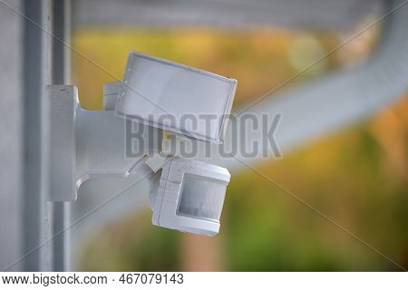Motion Sensor With Light Detector Mounted On Exterior Wall Of Private House As Part Of Security Syst