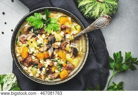 Winter Comfort Food. Warming High-calorie Oup With Pumpkin, Mushrooms, Potato, Beef And Barley. Gray