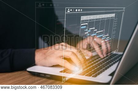 Project Manager Working On Laptop And Updating Tasks And Milestones Progress Planning With Gantt Cha