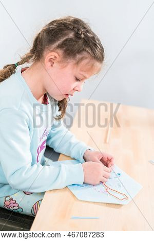 Little Girl Learning How To Sew With Sewing Craft Kit For Kids.