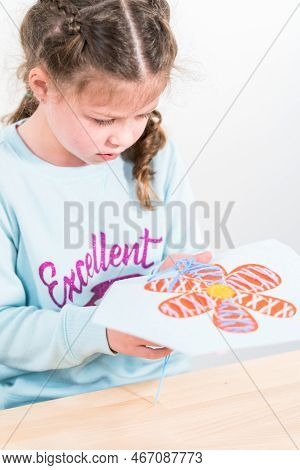 Little Girl Learning How To Sew With Sewing Craft Kit For Kids.