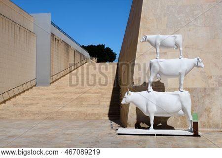 Valletta, Malta - August 28, 2018: A Sculpture Of Three Cows On Top Of Each Other By Joel Saliba And