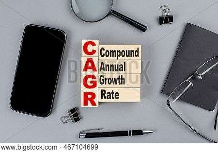 Wooden Cubes Cagr Wtih Notebook , Magnifier And Smartphone, Business