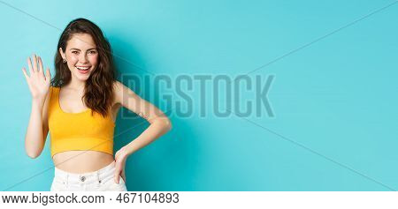 Summer Holidays And Emotions Concept. Cheerful Friendly Woman With Perfect Body, Waving Hand And Say