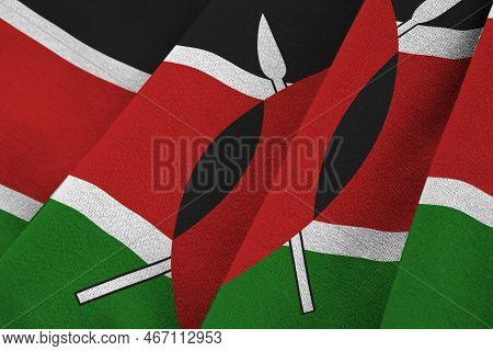 Kenya Flag With Big Folds Waving Close Up Under The Studio Light Indoors. The Official Symbols And C