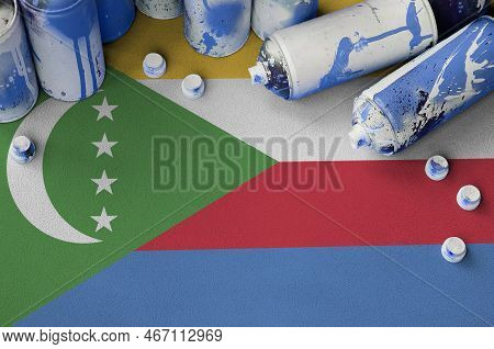 Comoros Flag And Few Used Aerosol Spray Cans For Graffiti Painting. Street Art Culture Concept, Vand