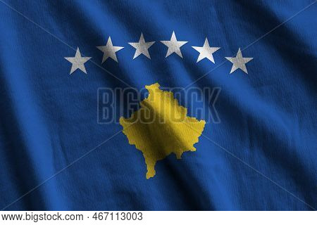 Kosovo Flag With Big Folds Waving Close Up Under The Studio Light Indoors. The Official Symbols And 