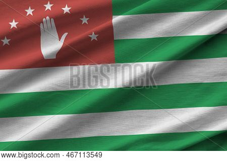 Abkhazia Flag With Big Folds Waving Close Up Under The Studio Light Indoors. The Official Symbols An