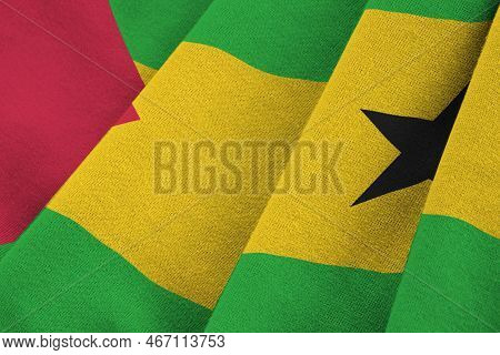 Sao Tome And Principe Flag With Big Folds Waving Close Up Under The Studio Light Indoors. The Offici