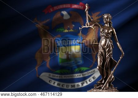 Michigan Us State Flag With Statue Of Lady Justice And Judicial Scales In Dark Room. Concept Of Judg