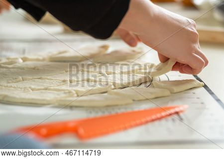 A Close-up View Of The Hands Of A Housewife In The Process Of Cooking Baursaks In The Kitchen