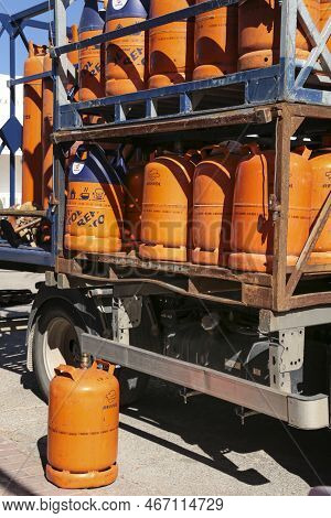 Madrid, Spain- December 13, 2022:truck Delivering Traditional Metal Butane Gas Bottles At Home In Sp