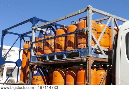 Madrid, Spain- December 13, 2022:truck Delivering Traditional Metal Butane Gas Bottles At Home In Sp