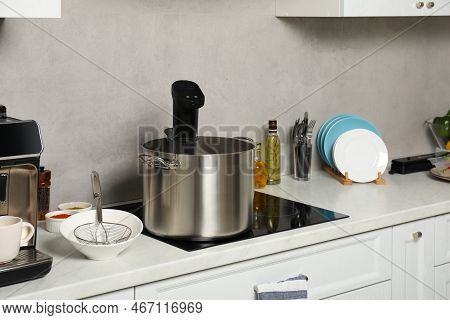 Pot With Sous Vide Cooker In Kitchen. Thermal Immersion Circulator