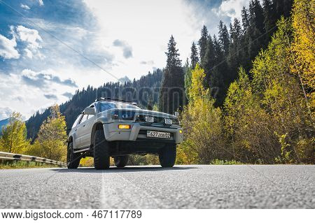 Japanese Off-road Used White 4x4 Car Toyota 4runner On Autumn Mountain Road Trip