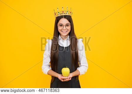 Princess Child In Queen Crown Hold Apple Isolated On Yellow Background. Teenage Girl Wear Diadem. Ha