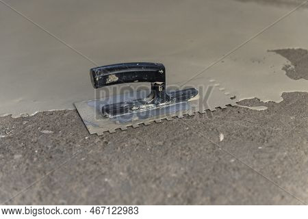 Construction Workers Are Painting The Floor Using The Method Self-leveling Epoxy.spreading Self Leve