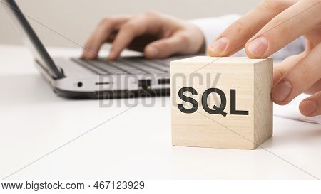 On A White Background, Wooden Blocks And Cubes With The Text Sql. Sql - Short For Sales Qualified Le