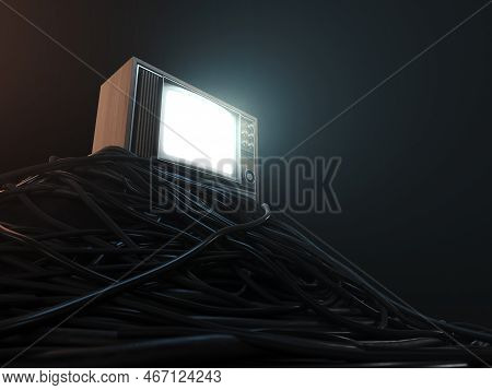 An Illuminated Vintage 80's Television Perched On A Jumbled Pile Of Black Cables On A Dark Omnious B