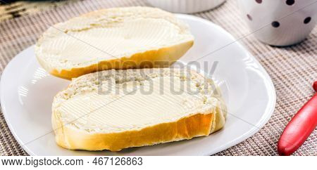 Slice Of Salt Bread Cut With Butter, Called French Bread In Brazil, Brazilian Breakfast