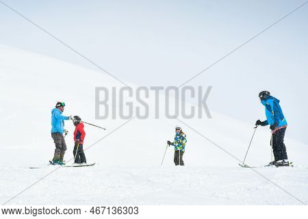 Gudauri, Georgia - 24th January, 2022: Caucasian Male Ski Instructor Teaching To Ski Family Two Kids