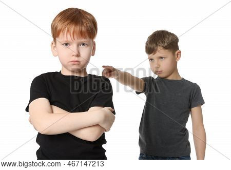 Boy Pointing At Upset Kid On White Background. Children's Bullying