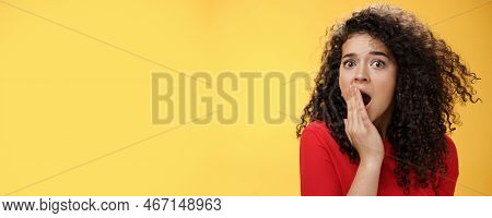 Close-up Shot Of Concerned And Shocked Worried Woman With Curly Hairstyle Open Mouth Wide And Coveri