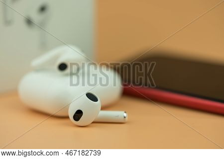 Bangkok, Thailand - December 14, 2022 : New Apple Airpods 3 On A Orange Background.